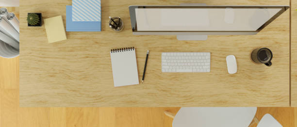 istock Top view of desk top computer and stationery on wooden table, 3D rendering 1324806162
