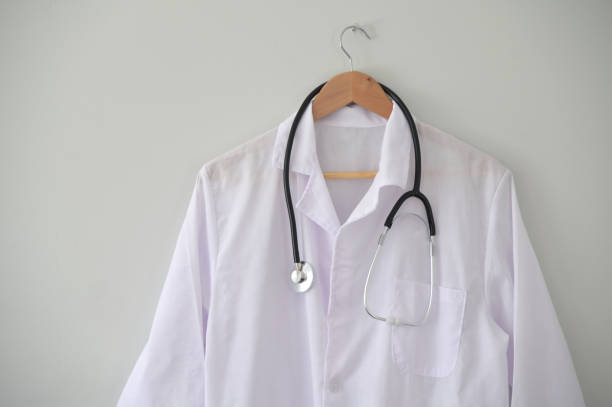 istock Doctor coat hanged on clinic office wall 1324810137