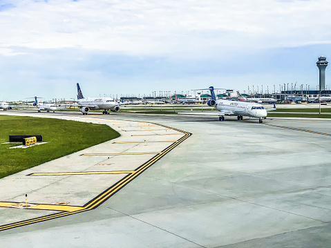 Chicago, USA - June 4, 2021: Several United Airlines planes lined up on taxiway waiting for departure at Chicago O'Hare International Airport (ORD). O'Hare is the world's sixth-busiest airport and serves as United Airlines' hometown hub.