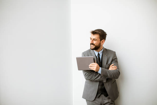 istock Young modern businessman using digital tablet in the office 1324814124