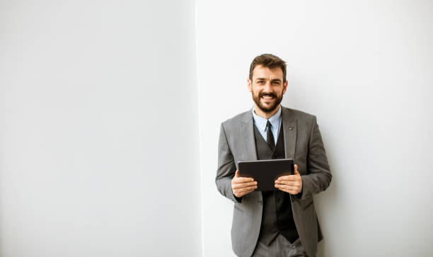 istock Young modern businessman using digital tablet in the office 1324814129