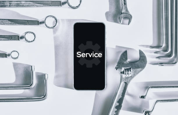 istock Repair phone. Technician workplace with phone and special repairing tools. Disassembling, diagnostic and repairman smartphone. 1324816527
