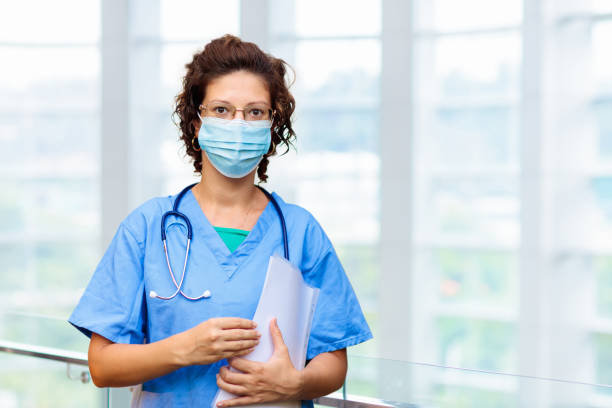 istock Doctor or nurse with stethoscope and face mask. 1324817296