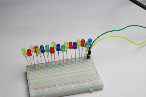 istock Multicolor LED are connect to solderless breadboard laid flat on white background which shows electrical hobby projects concept 1324818559