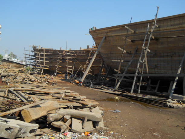 Mandvi, Gujarat, India - January 2011: A wooden ship under construction at the ship building yard in the coastal town of Mandvi in Kutch.