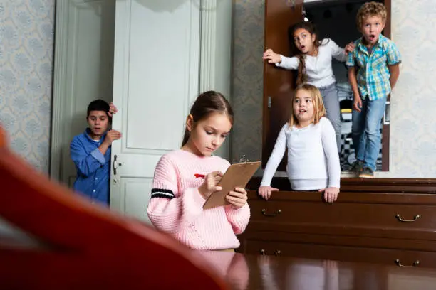 Photo of Tween girl solving conundrum to get out of escape room