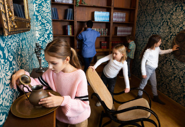 istock Tween girl examining ancient kettle in quest room 1324821547