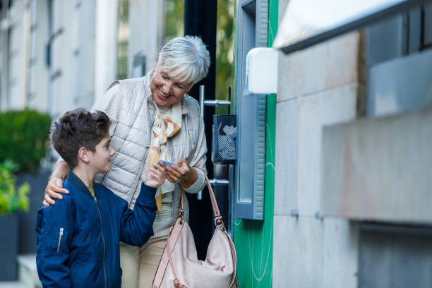 istock Senior Woman and her Grandson are Using an ATM Machine. 1324822320