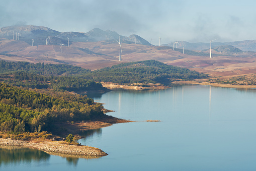 Guadalteba reservoir in the province of Malaga with a wind farm in the background. Andalusia, Spain