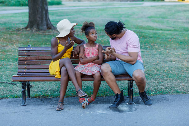 istock An African Family is Talking About the Problems in Public Park. 1324824810