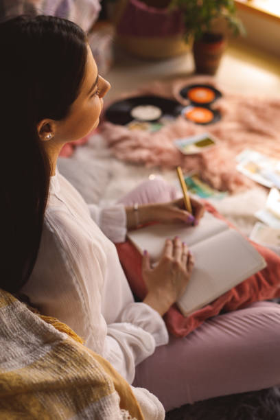 istock High angle view of young woman writing in a diary 1324826205