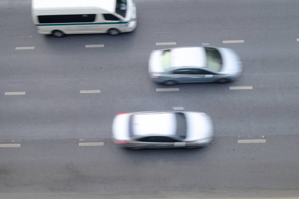 istock Motion blurred of automobile moving on road with speed on top view, background 1324826268