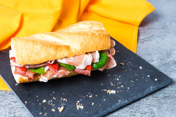 istock Sandwich with Serrano ham, Iberian shoulder, piquillo peppers and arugula 1324828227
