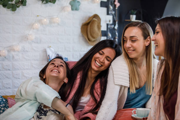 istock Girlfriends laughing and bonding morning after a sleepover party 1324829539