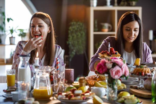 istock Two women sitting at table, having brunch 1324830357
