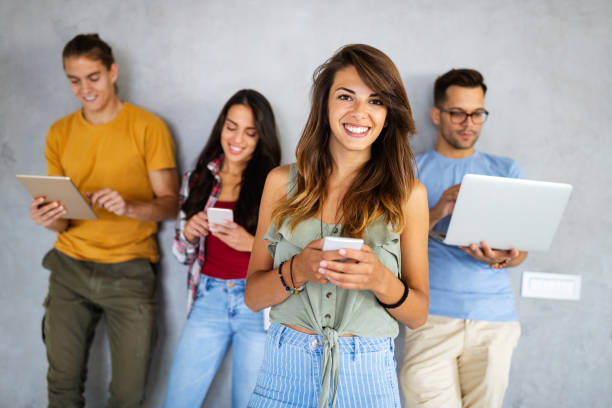 istock Education, technology and people concept. Happy group of friends using digital devices 1324831603