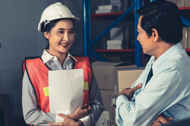 istock Warehouse manager and worker working in the storehouse 1324831673