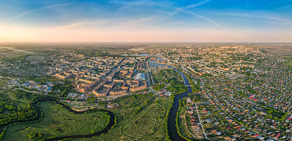 A picturesque cityscape of Yoshkar-Ola, the Volga region, Russia. The aerial view on all small city with suburbs, the river, embankment and the residential districts. Outdoors shooting at early morning, summer, sunny day