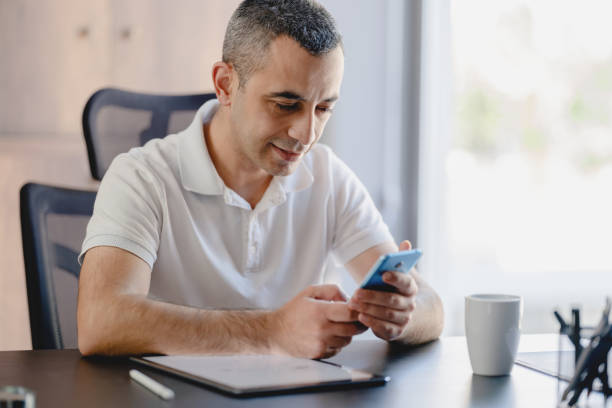 istock Man Working In The Office Using Digital Tablet And Smartphone 1324832122