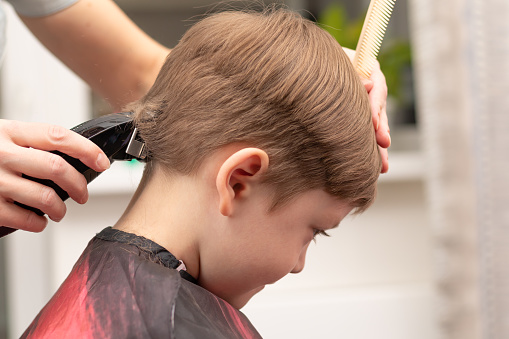 Young Mom Hairdresser Cuts Her Baby Boy At Home With Hair Clipper During  Quarantine Selective Focus Stock Photo - Download Image Now - iStock