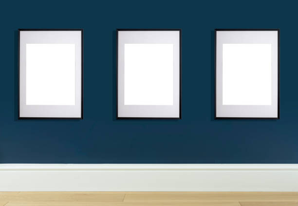 istock Mock up poster frame in interior wall. White frame for poster or photo image on blue wall in home room or office interior 1324834064