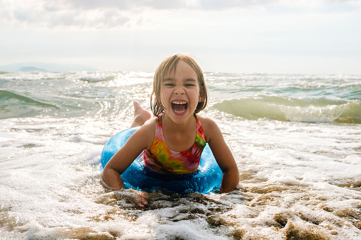 Child Girl Swimming In The Sea