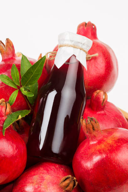 istock Pomegranate fruit in wooden box and pomegranate juice 1324835788