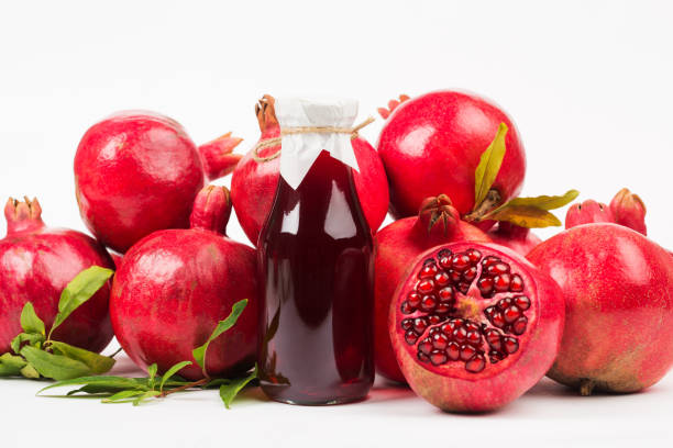 istock Pomegranate fruit in wooden box and pomegranate juice 1324835946
