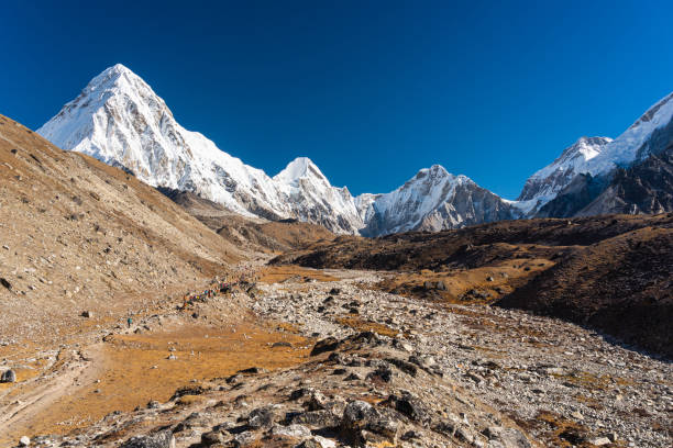 istock Trekking trail to Everest base camp surrounded by Himalaya mountains range in Nepal 1324838280
