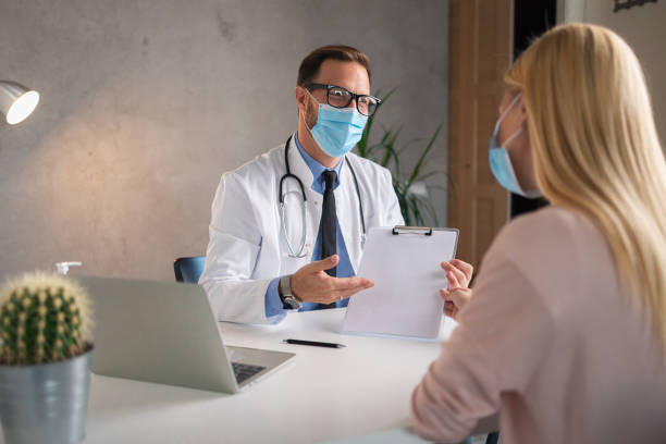 istock Young doctor holding blank clipboard 1324839991