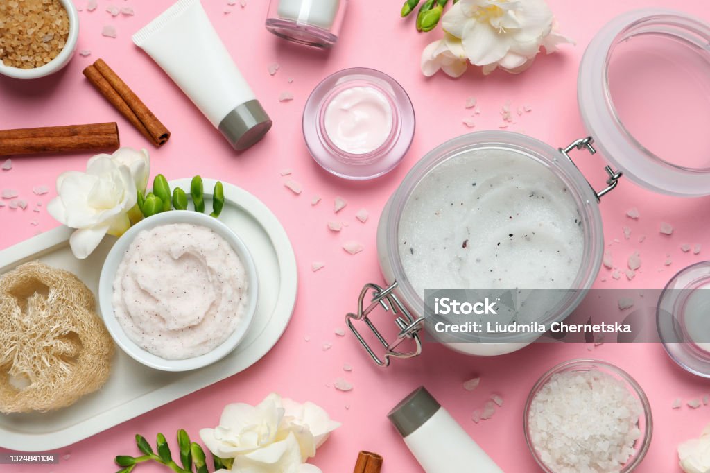 Flat lay composition with body scrubs on pink background Exfoliation Stock Photo