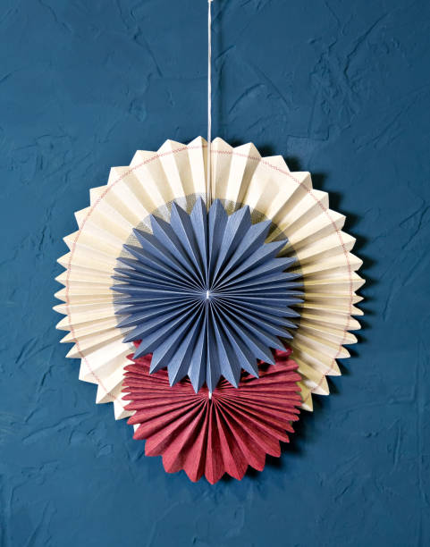 istock Round paper harmonica Interior decoration: paper circles on the blue wall 1324841705