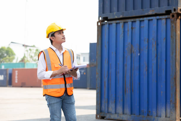 istock factory worker or engineer writing on clipboard in containers warehouse storage 1324841761