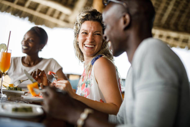 istock Cheerful friends talking during their lunch at a restaurant. 1324842434