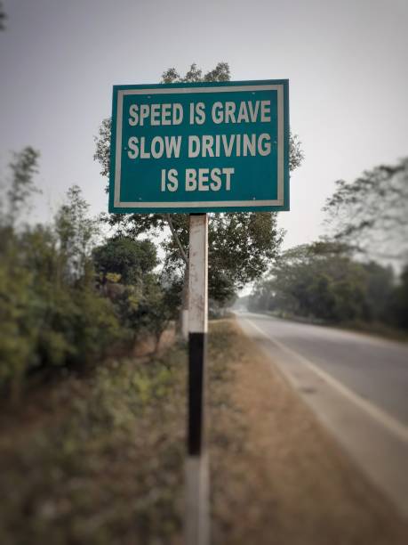 istock white color 'speed is grave slow driving is best' text on blue color rectangular board at the highway 1324843074