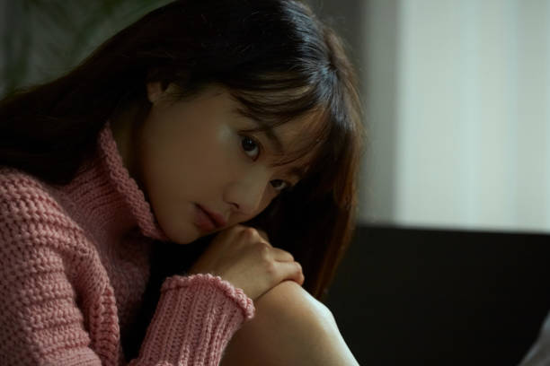istock A young Asian woman is relaxing on the bed 1324843770