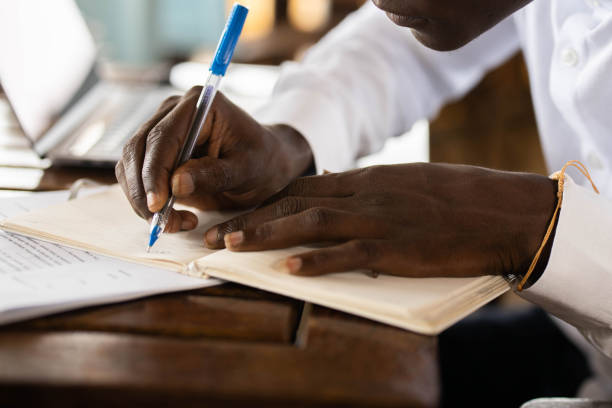 istock Close up of a black businessman taking notes. 1324844118