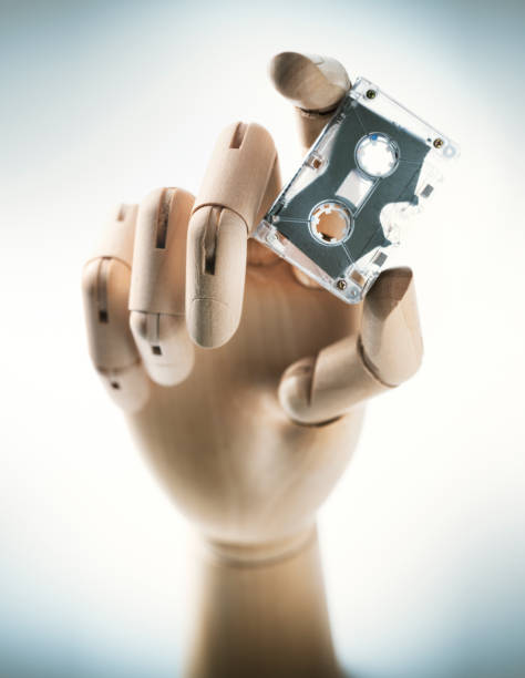 istock Wooden Hand with Audio Tape 1324844421