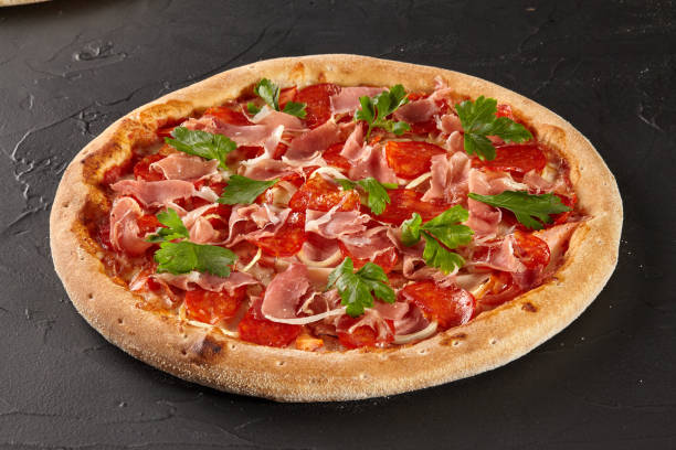 istock Meat pizza with salami, bacon and prosciutto 1324844518