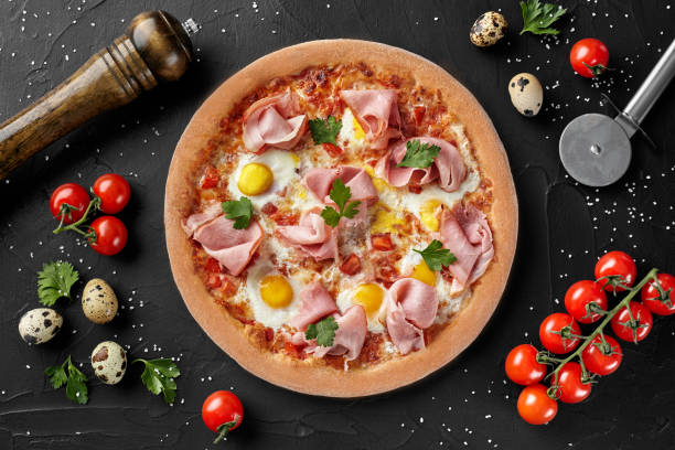 istock Top view of pizza with quail eggs and ham 1324845469