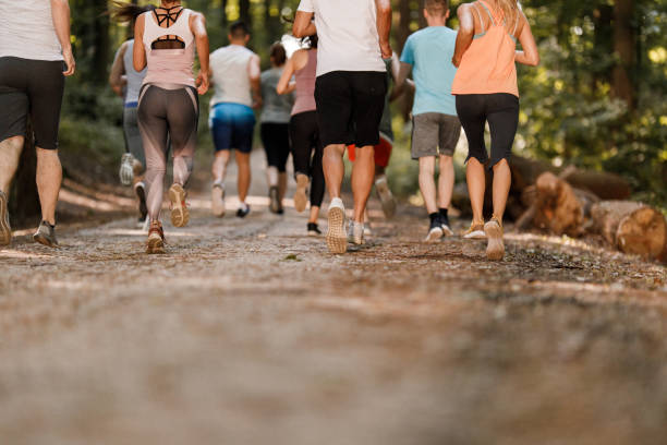 istock Rear view of unrecognizable athletes running a marathon. 1324845543