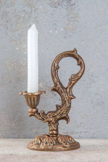 istock Antique candlestick on concrete background 1324845606