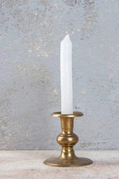 istock Antique candlestick on concrete background 1324845644
