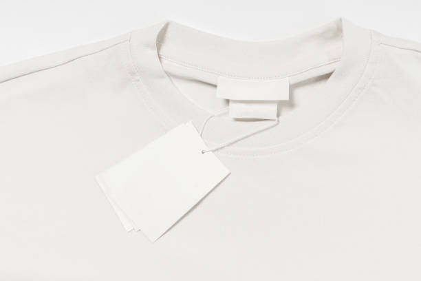 istock Blank paper label on a white cotton clothing 1324845982