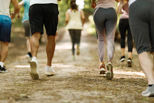 istock Back view of unrecognizable athletes running a marathon in nature. 1324846008