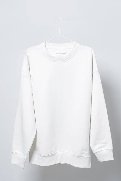 istock Blank white sweatshirt hanging on a hanger against gray background 1324846853
