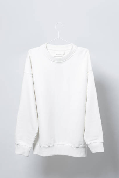 istock Blank white sweatshirt hanging on a hanger against gray background 1324846881