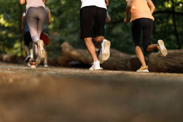 istock Rear view of unrecognizable athletes jogging in nature. 1324847120