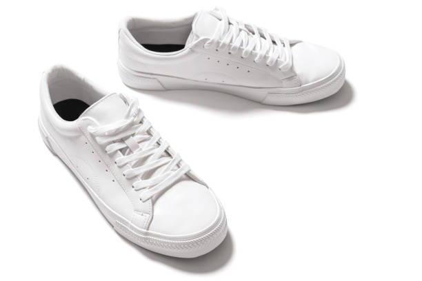istock Pair of white leather trainers on white background 1324847216