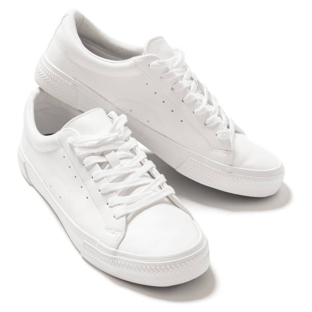 Pair of white leather trainers on white background Pair of white leather trainers with a shadow on white background shoes stock pictures, royalty-free photos & images